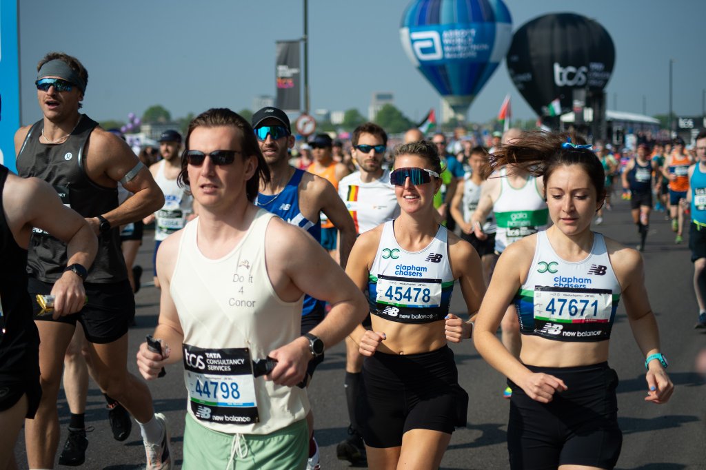 Child reaching out to touch runners hand